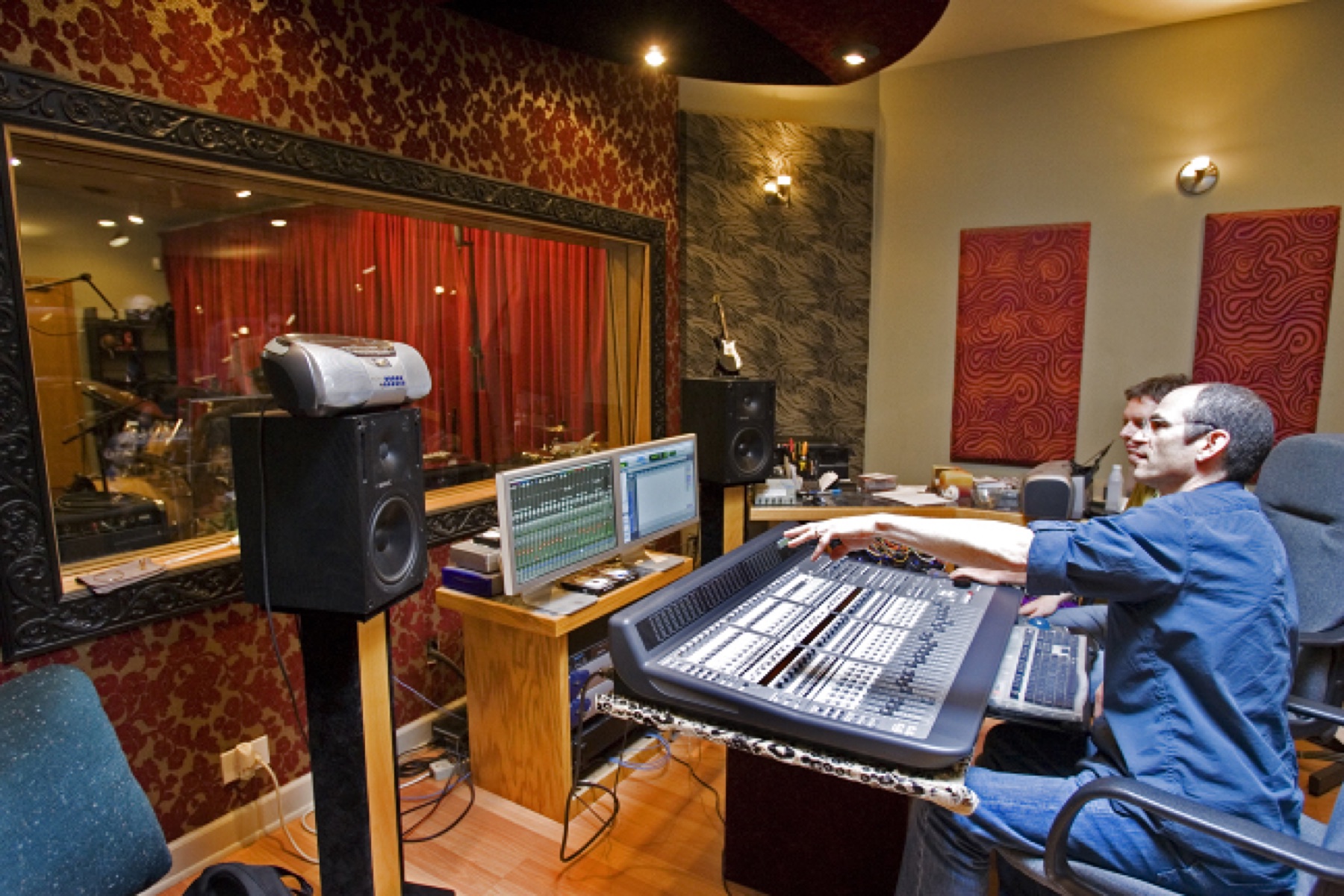 A recording engineer working at a studio control-room console