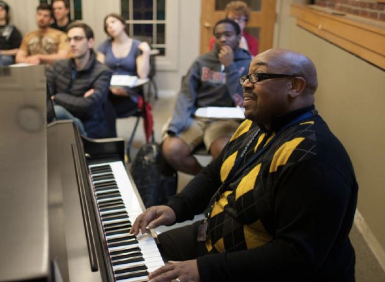 A piano teacher demonstrating musical ideas for students